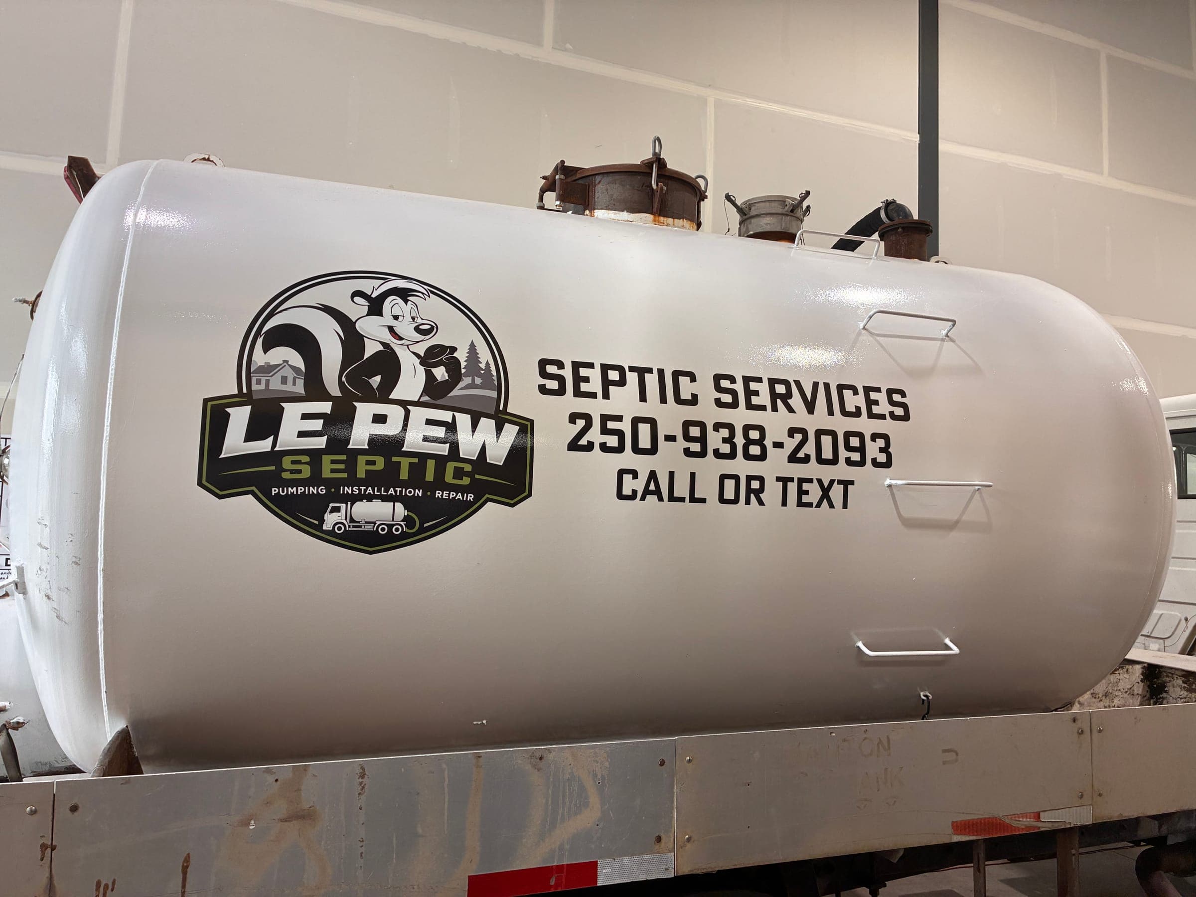 The Le Pew Septic vacuum tank, branded with the phone number